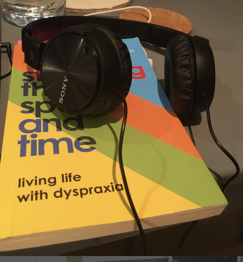 Sony headphones on top of a copy of the book 